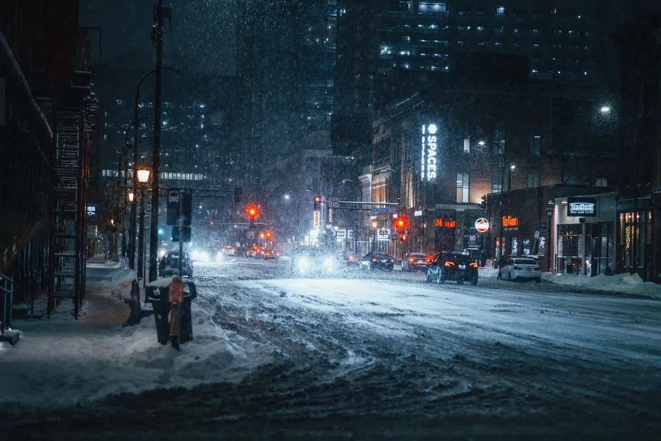 A snowy evening on an urban street in downtown Minneapolis, captured with streetlights illuminating the falling snow.